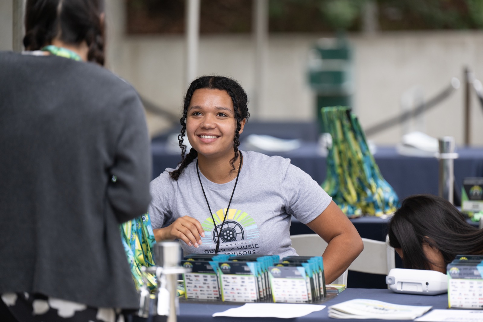 Conference attendee checking in at a GMS event table